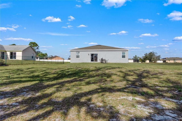 rear view of property with a lawn