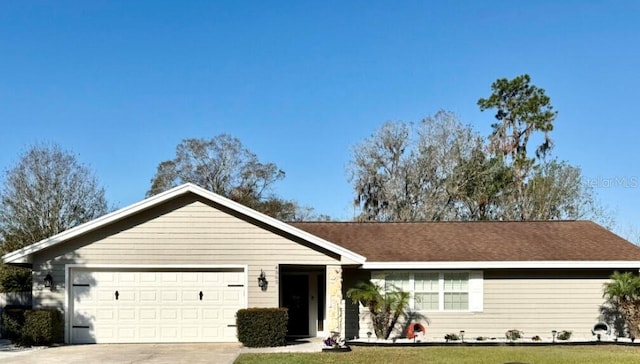 single story home with a garage and a front lawn