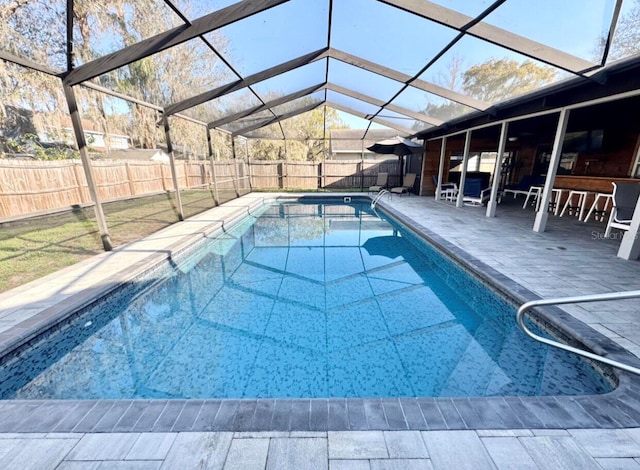 view of swimming pool featuring a bar, a lanai, and a patio area