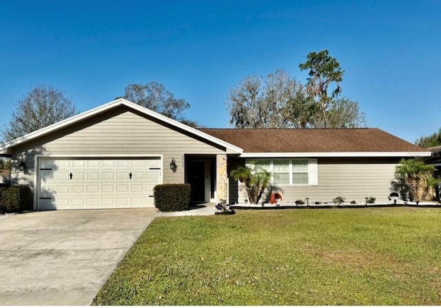 ranch-style home featuring a garage and a front lawn