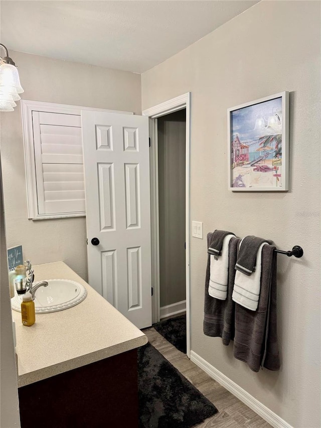 bathroom with vanity and hardwood / wood-style floors