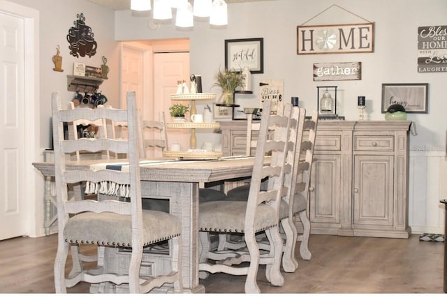 dining room with dark hardwood / wood-style floors and a chandelier