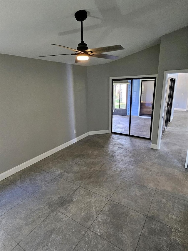 empty room with ceiling fan and lofted ceiling