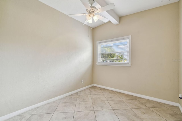 empty room with lofted ceiling with beams, light tile patterned flooring, a ceiling fan, and baseboards