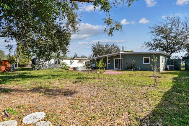 view of yard featuring cooling unit and fence