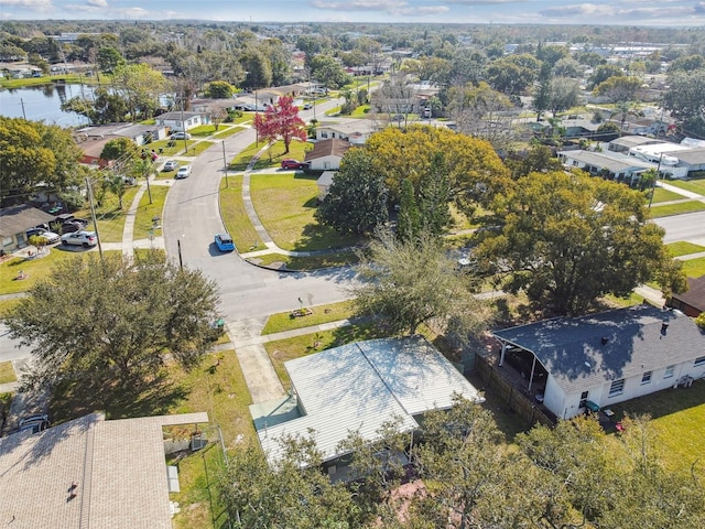 drone / aerial view featuring a residential view and a water view