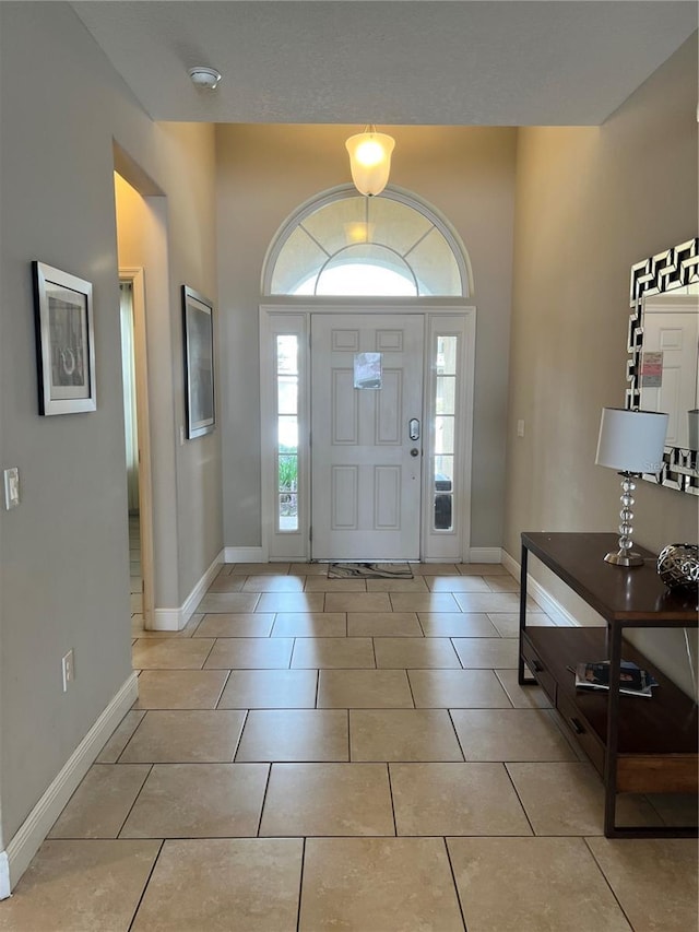 entryway with light tile patterned floors