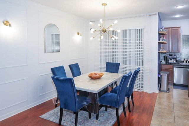 dining area featuring an inviting chandelier and light hardwood / wood-style floors