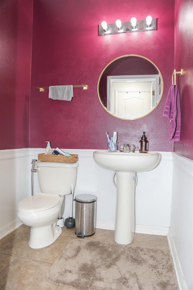 bathroom with tile patterned floors and toilet