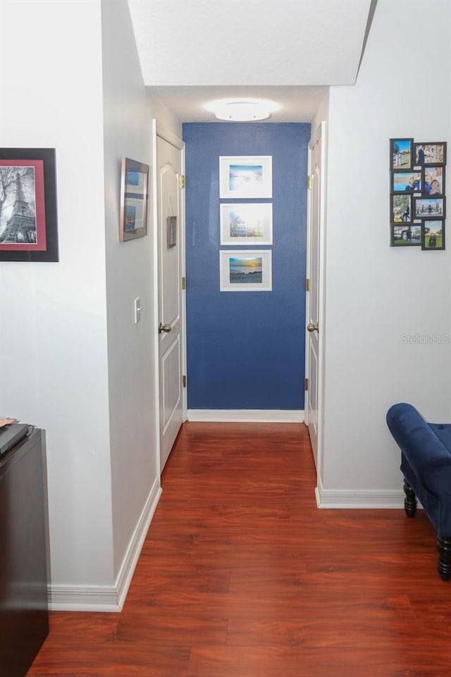 corridor featuring dark hardwood / wood-style floors