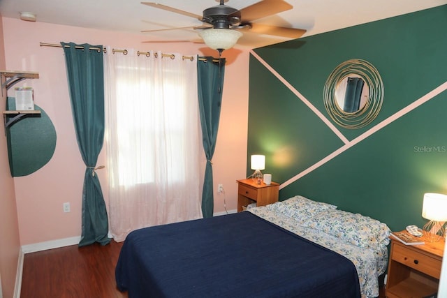 bedroom with ceiling fan, dark hardwood / wood-style floors, and multiple windows