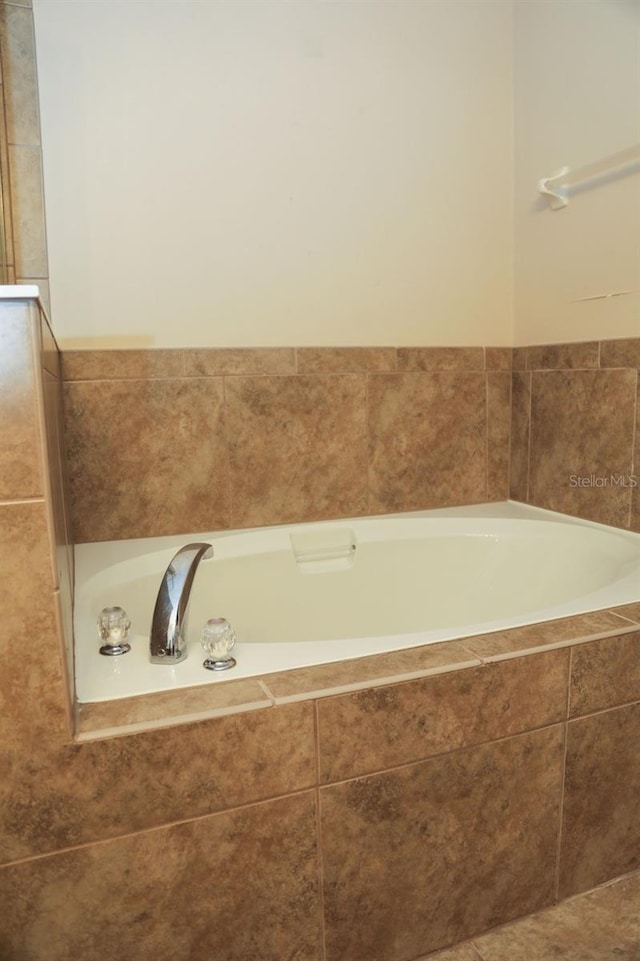 bathroom with a relaxing tiled tub