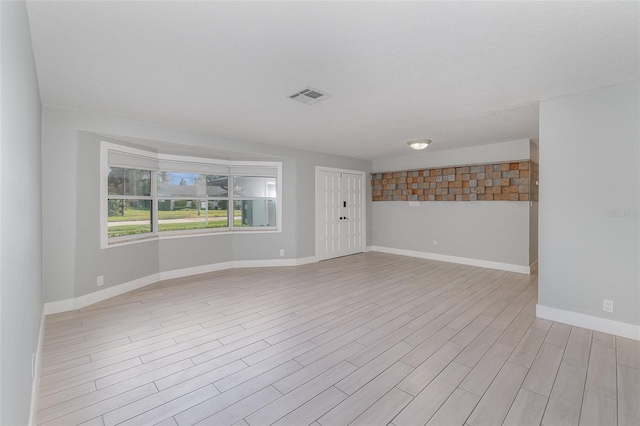 spare room with light hardwood / wood-style floors