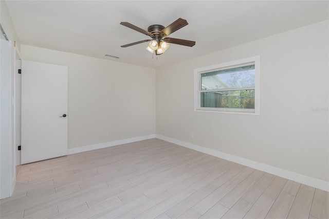 empty room featuring light hardwood / wood-style flooring and ceiling fan