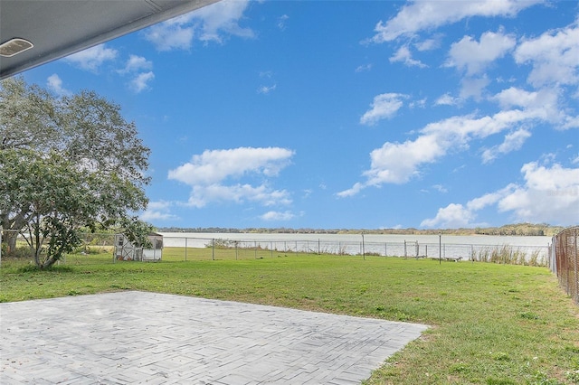 view of yard with a patio and a water view