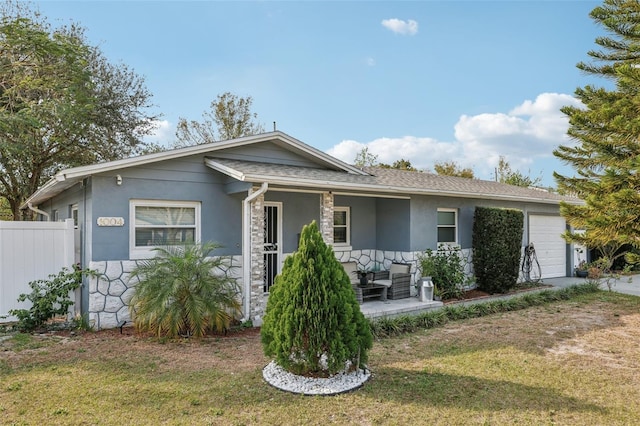 view of front of house with a porch, a garage, and a front yard