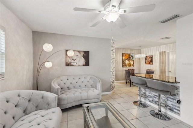 living room featuring ceiling fan and light tile patterned flooring