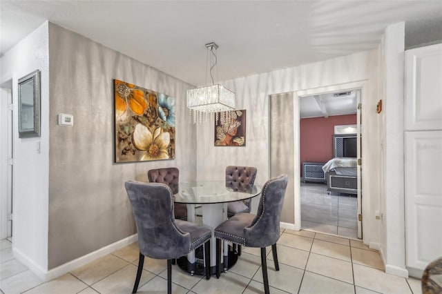 tiled dining room featuring an inviting chandelier