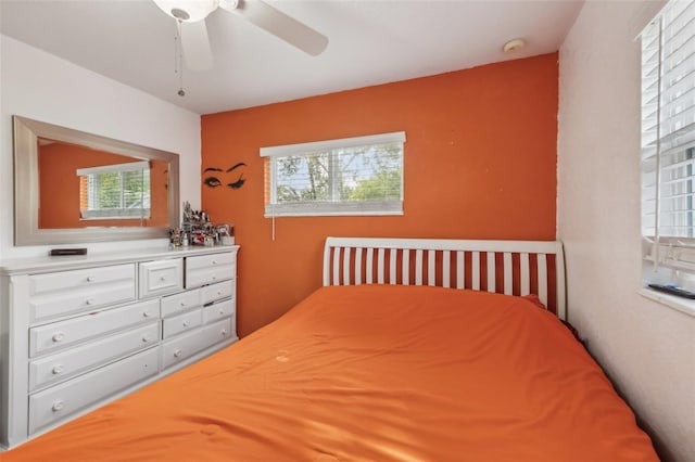 bedroom with multiple windows and ceiling fan