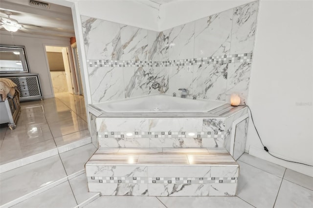 bathroom with ceiling fan and tiled tub