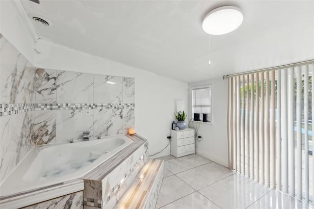 bathroom featuring tile patterned floors and tiled bath