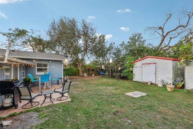 view of yard featuring a patio area and a shed