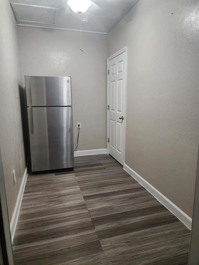 kitchen with stainless steel refrigerator and dark wood-type flooring