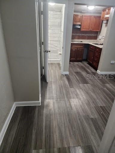 interior space with extractor fan, dark wood-type flooring, and sink