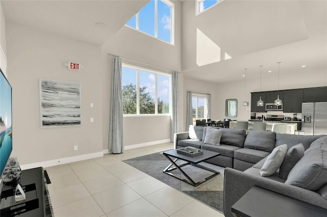 tiled living room featuring a high ceiling