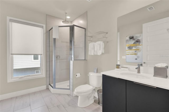 bathroom featuring a shower with door, vanity, and toilet