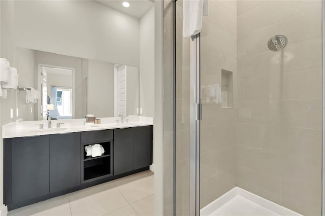 bathroom featuring tile patterned flooring, vanity, and walk in shower