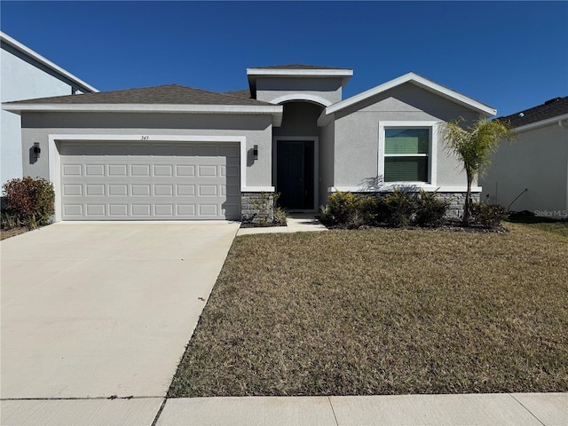 view of front of house featuring a garage and a front lawn