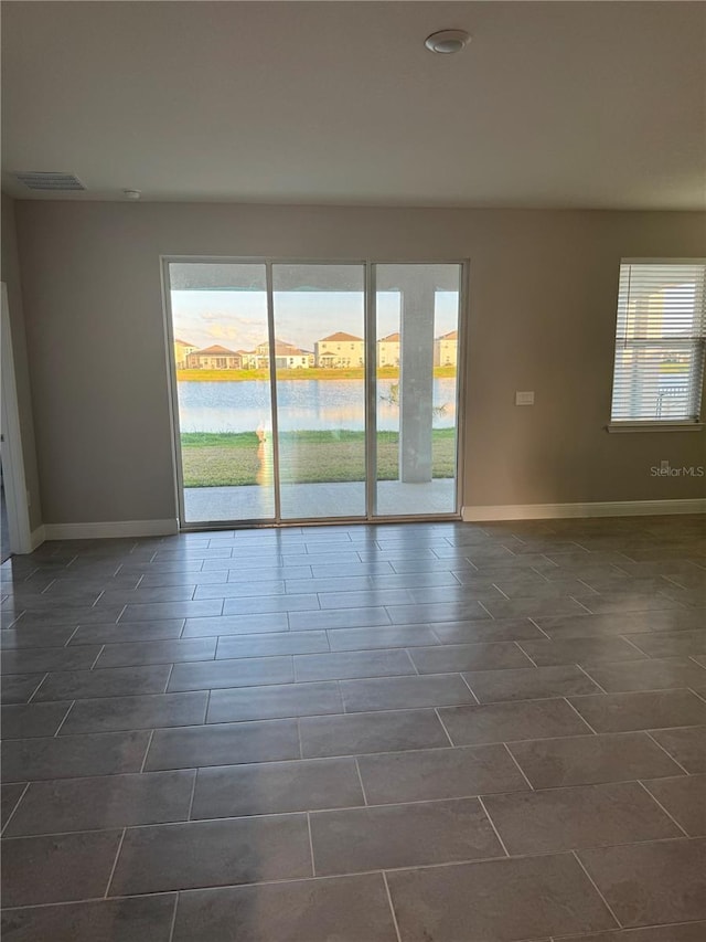 spare room with visible vents and baseboards