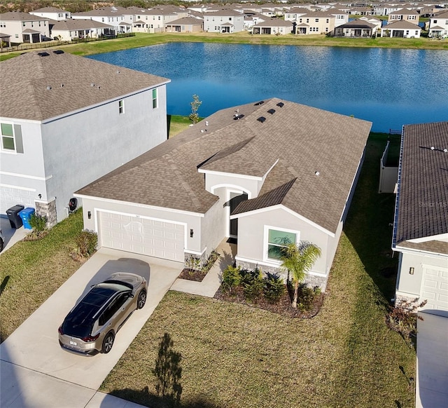 bird's eye view featuring a water view and a residential view