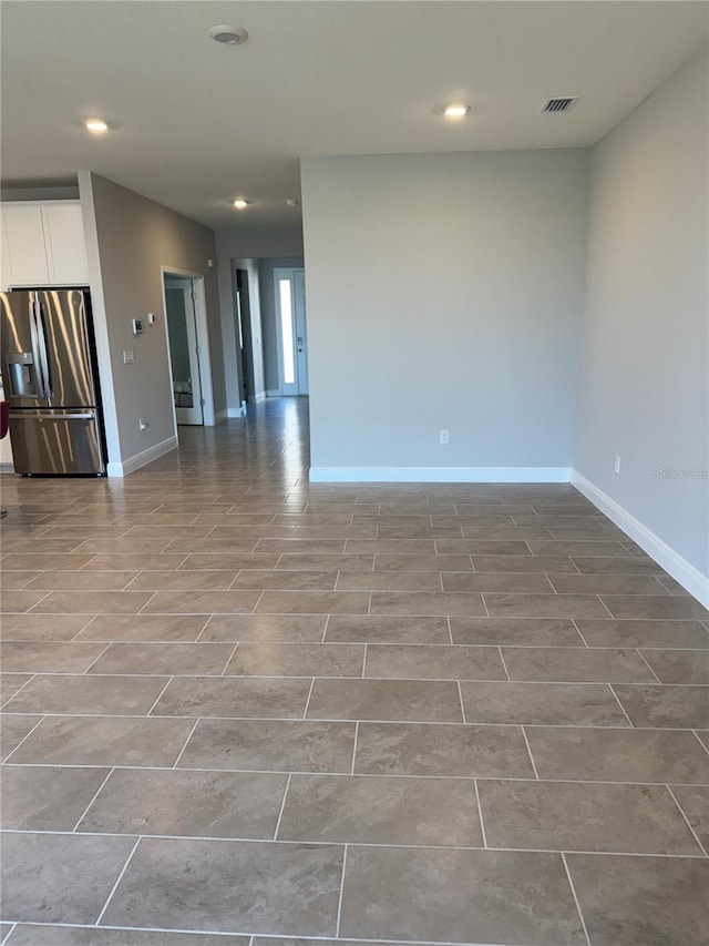 empty room with visible vents, recessed lighting, and baseboards