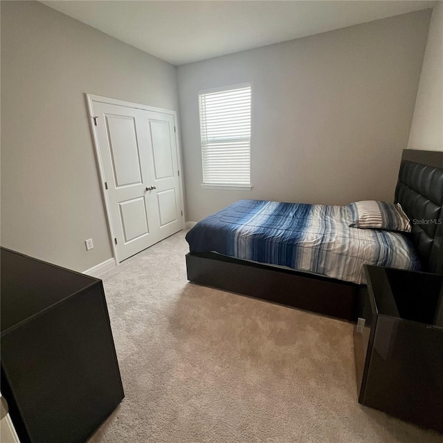 carpeted bedroom with baseboards