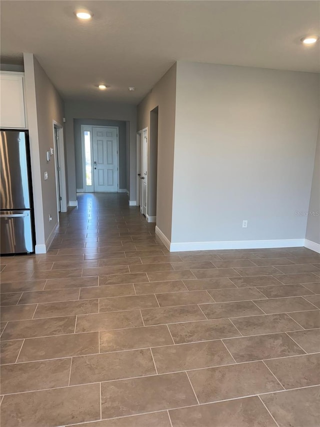 corridor with recessed lighting and baseboards