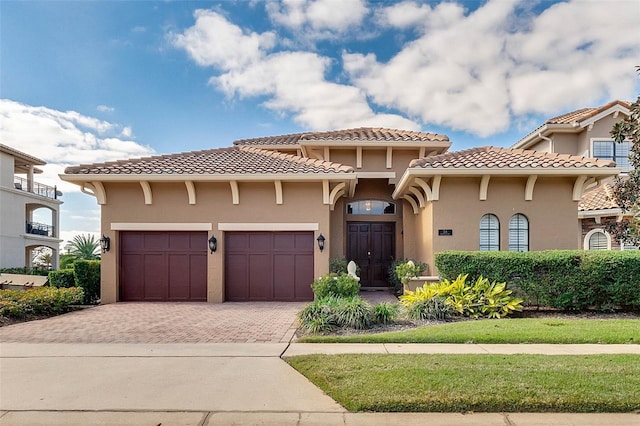 mediterranean / spanish home with a garage