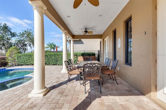 view of patio / terrace featuring a pool with hot tub and ceiling fan