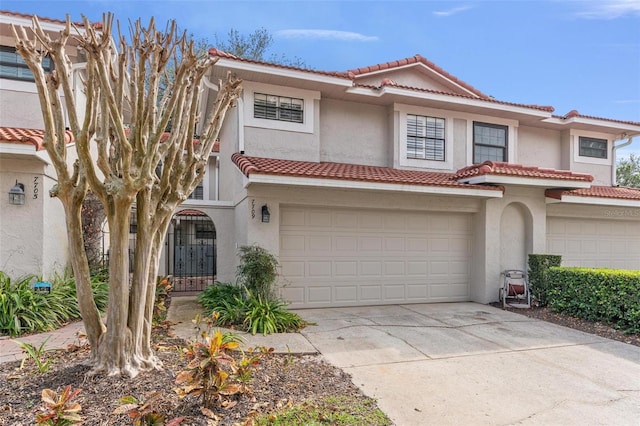 mediterranean / spanish-style house with a garage