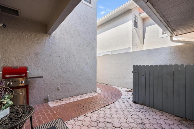 view of patio / terrace featuring a grill and radiator heating unit