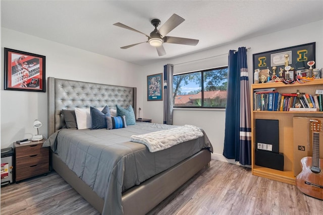 bedroom featuring hardwood / wood-style flooring and ceiling fan