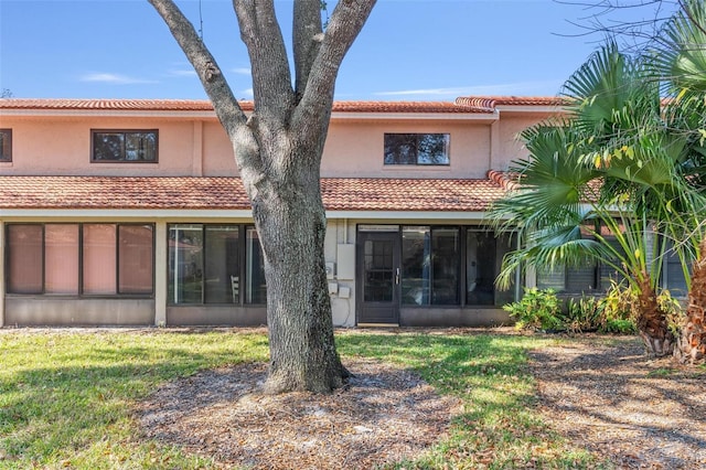 rear view of property with a lawn