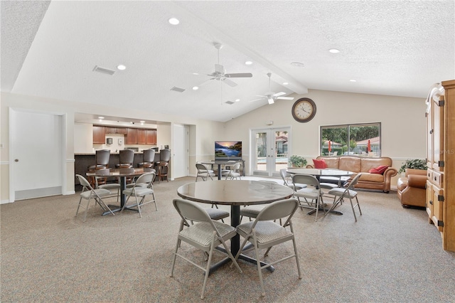 carpeted dining area featuring beam ceiling, high vaulted ceiling, a textured ceiling, and french doors