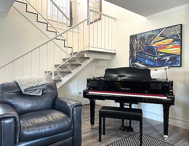 sitting room featuring wood-type flooring and crown molding