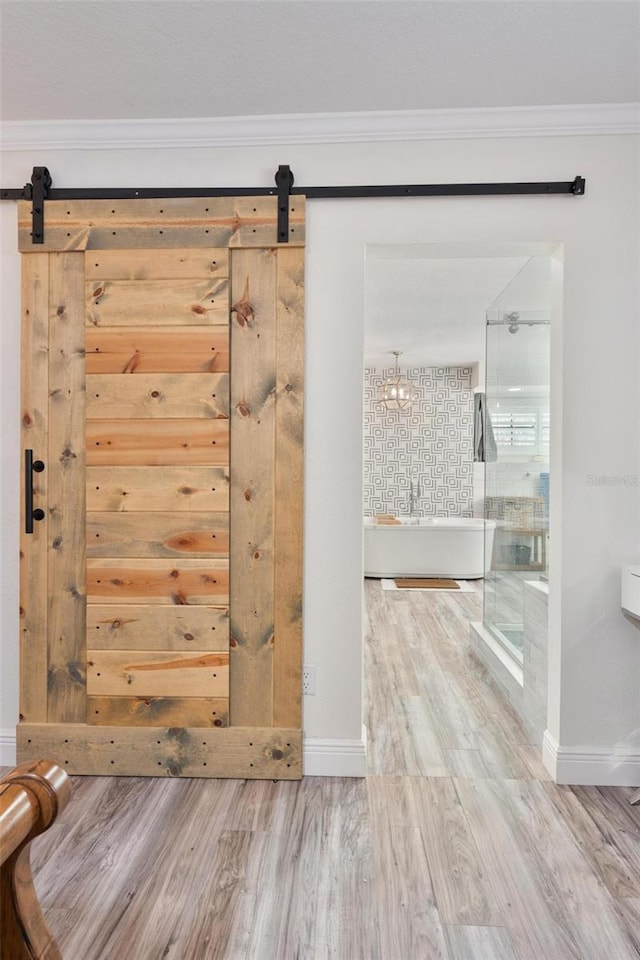 bathroom featuring hardwood / wood-style floors, crown molding, and a bathing tub