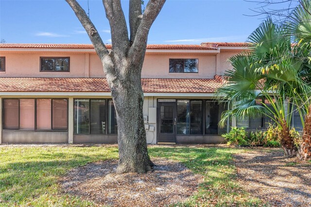 rear view of property featuring a yard