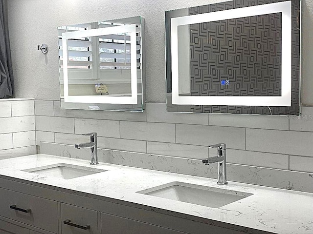 bathroom with vanity and decorative backsplash