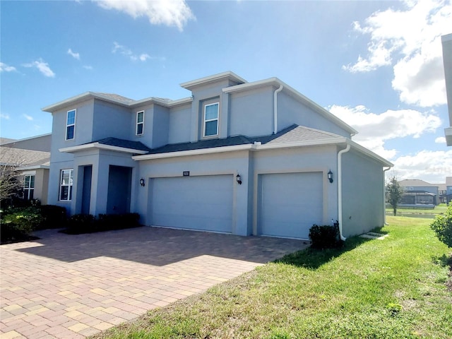 view of front facade featuring a garage and a front lawn