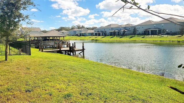 view of dock featuring a water view and a lawn